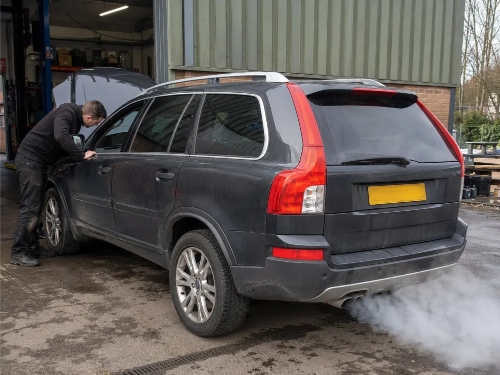 Engine overheating and smoke warning signs on a vehicle in Guildford